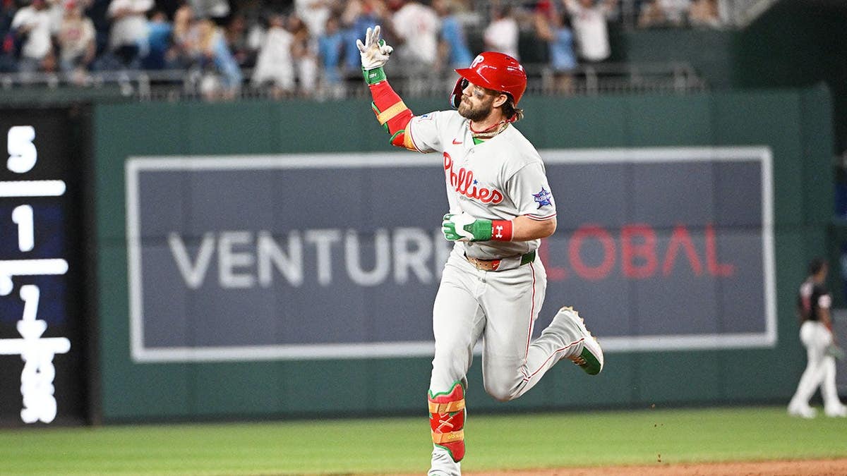 Bryce Harper celebrating after hitting a three-run home run at Nationals Park.