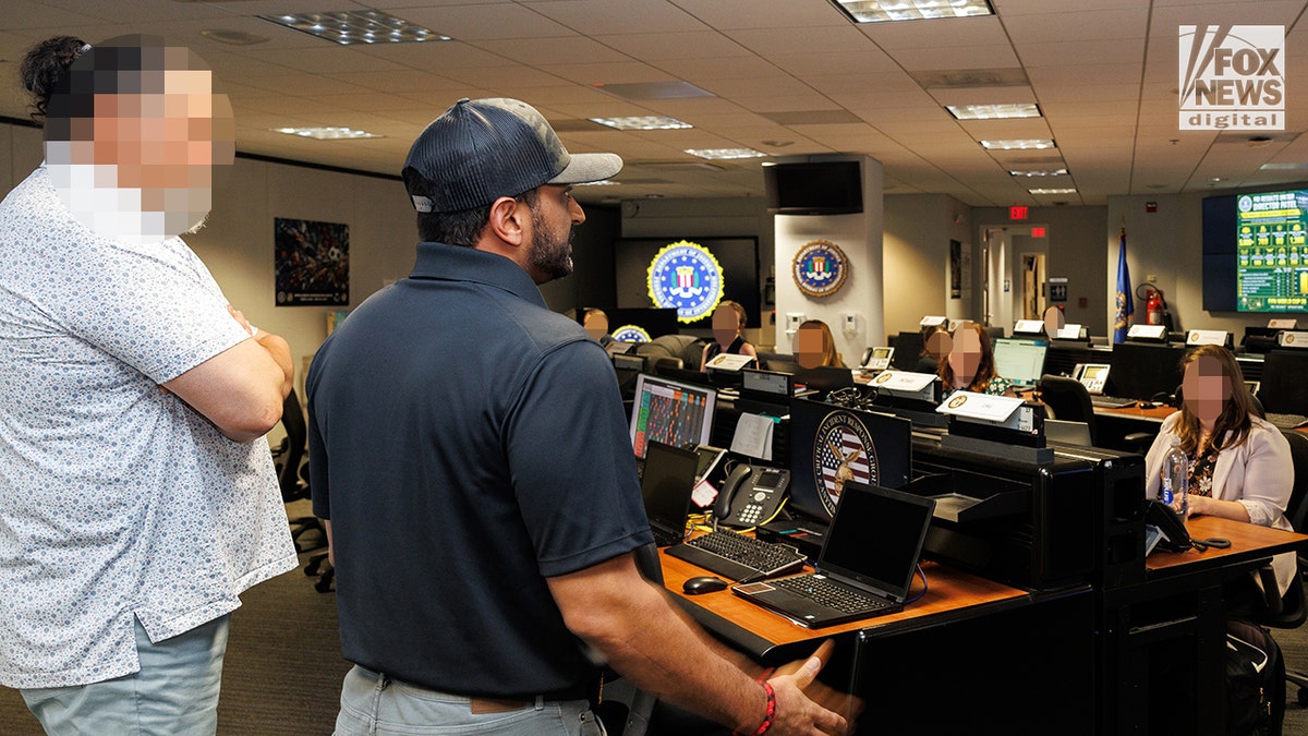 Kash Patel speak to an audience at the FBI headquarters.