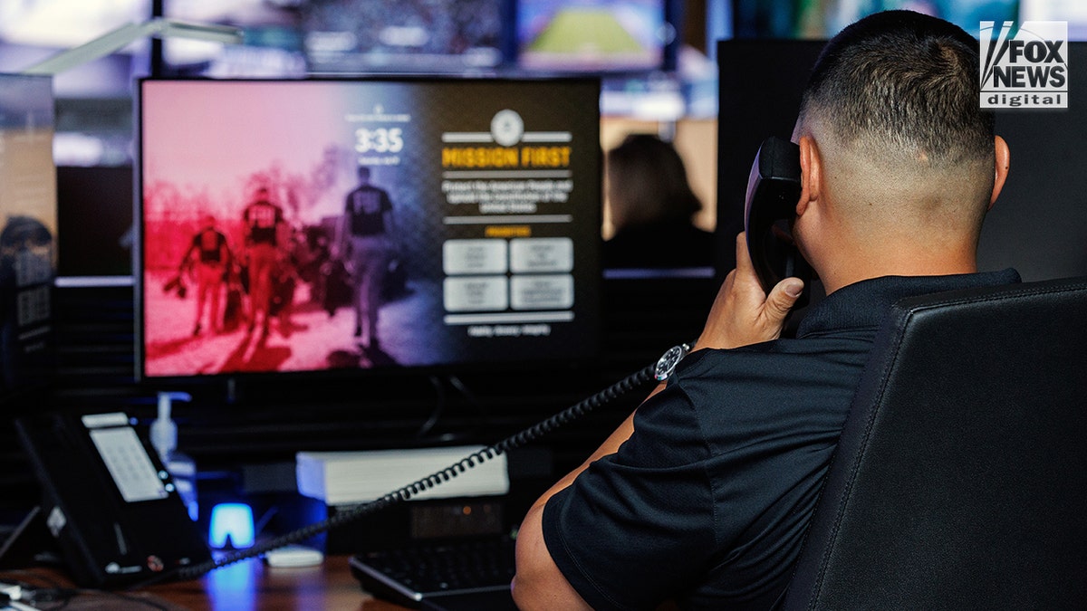 An agent makes a call on a phone.