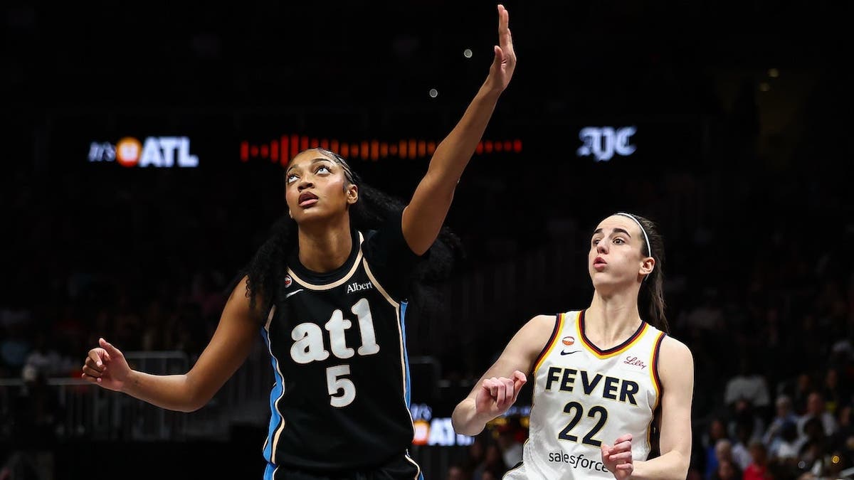 Caitlin Clark shooting a basketball against Angel Reese at State Farm Arena in Atlanta
