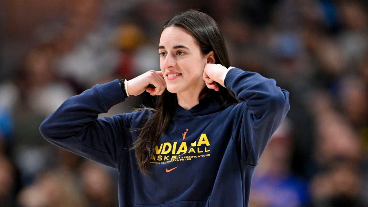 Caitlin Clark stands on the court during a WNBA game.