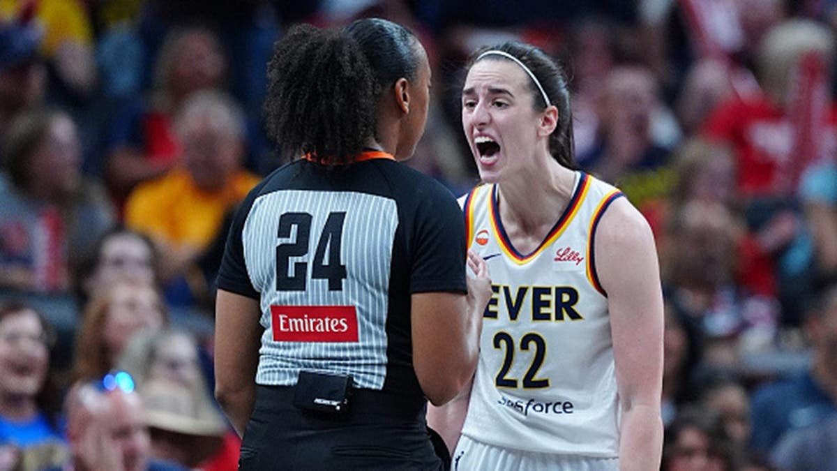 Caitlin Clark gestures toward a referee during a game at Gainbridge Fieldhouse.