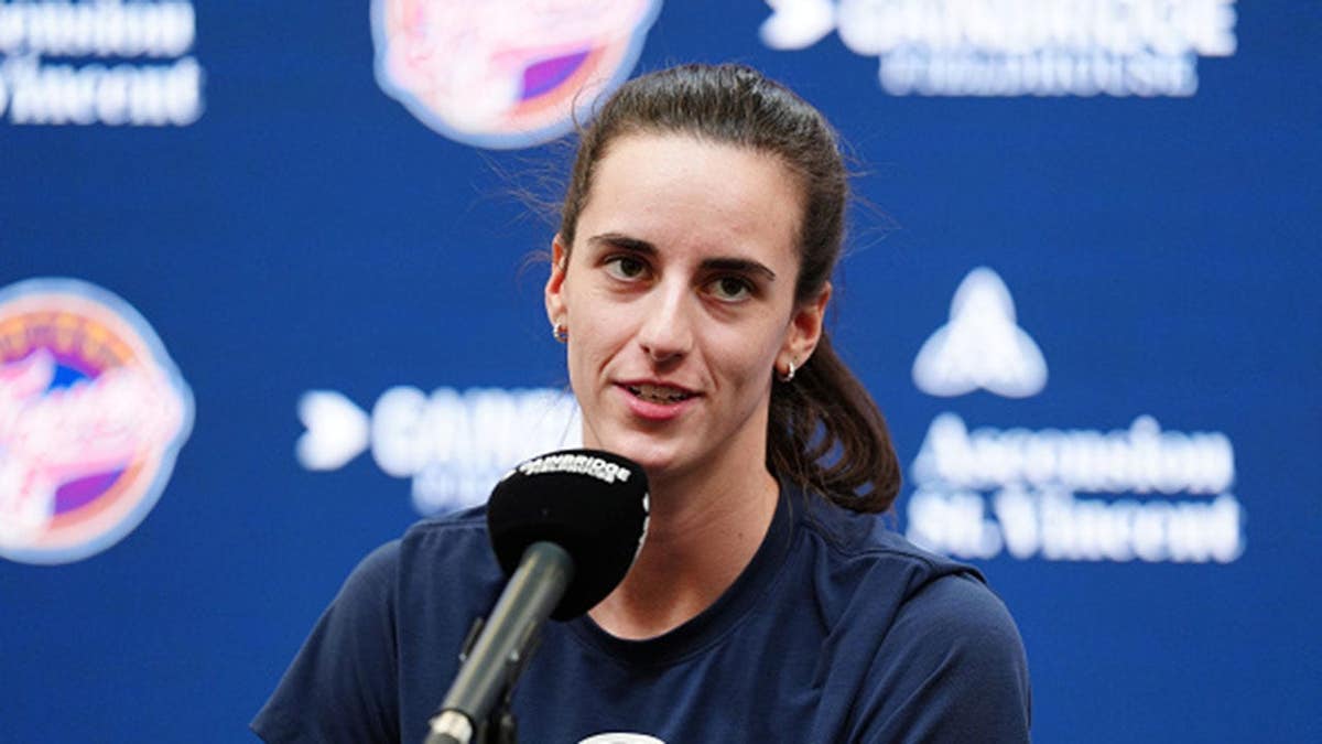 Caitlin Clark speaks to the media at a press conference.