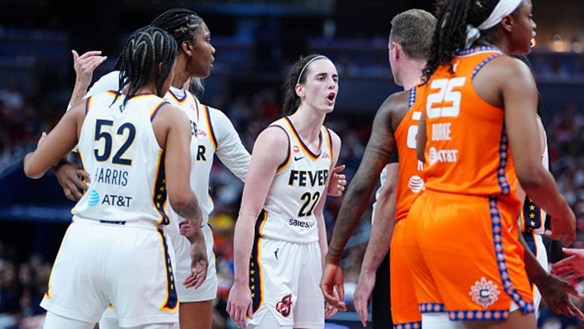 Caitlin Clark and Saniya Rivers exchange words as a referee steps between them.