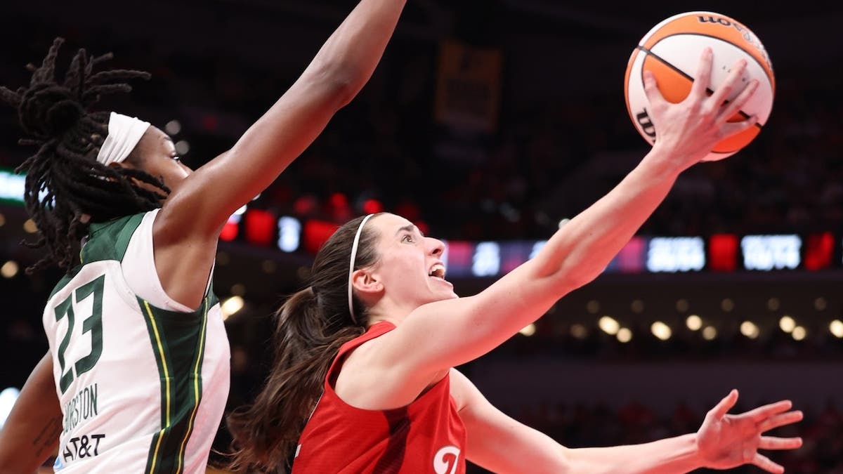 Caitlin Clark drives to the basket during a game against the Seattle Storm.