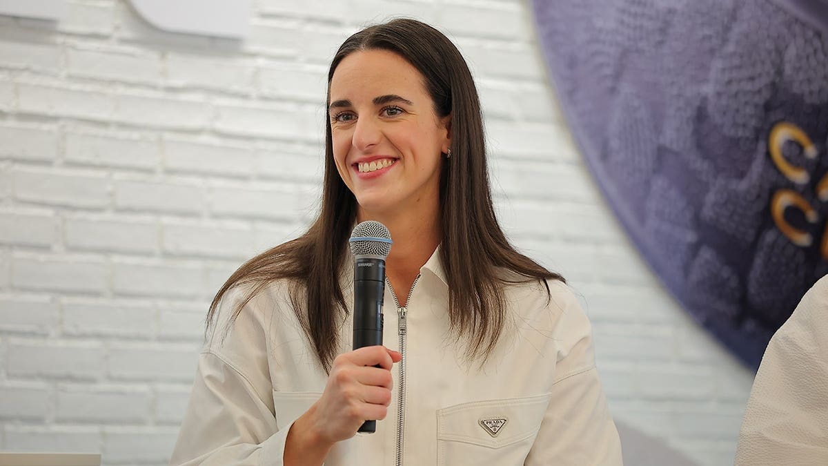 Caitlin Clark stands at Wilson Flagship Store in Chicago.