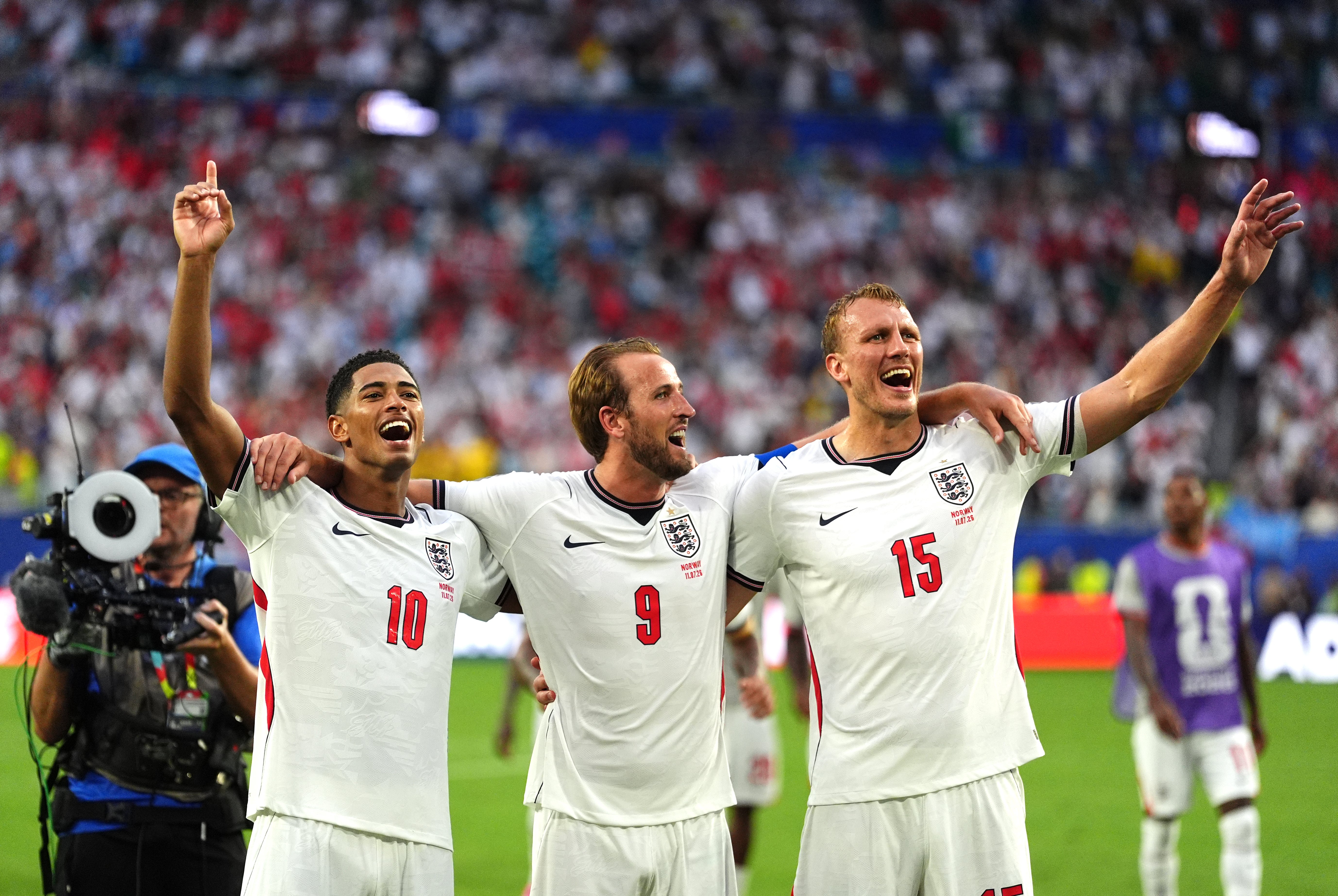 England’s Jude Bellingham, Harry Kane and Dan Burn sign Wonderwall after the quarter-final win against Norway (Martin Rickett/PA)