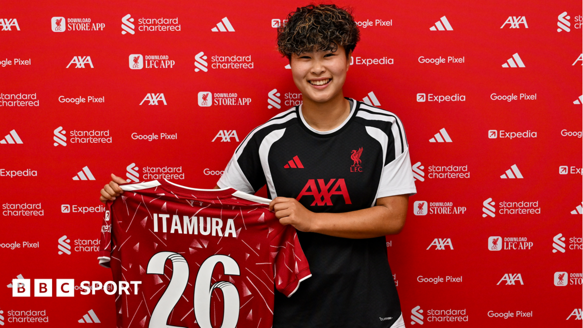 Mao Itamura holds up a Liverpool shirt bearing her surname and the number 26 on the back