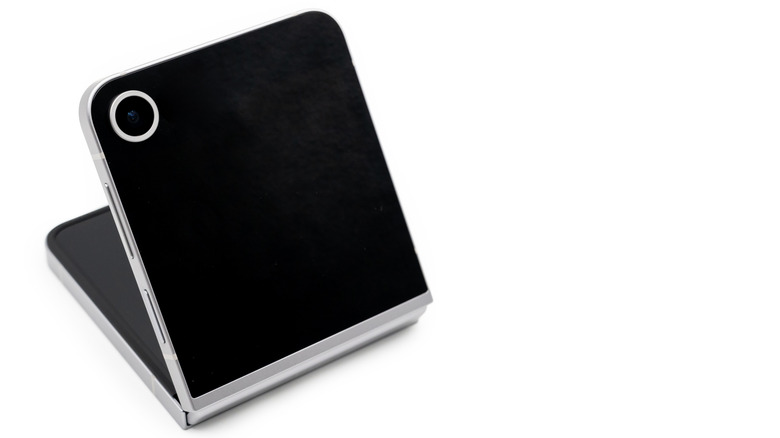 A half-folded clamshell smartphone on a white background