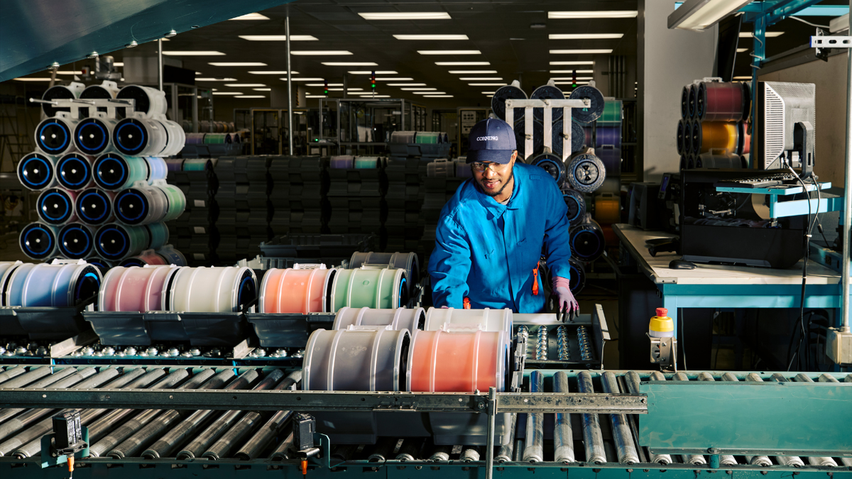 A Corning technician inspects optical fiber before it moves to the next stage of production.
