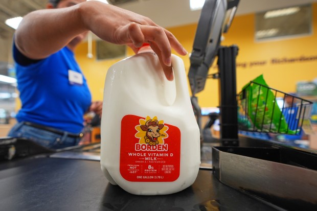 A cashier rings up a gallon of milk at a grocery store in Dallas, April 15, 2026. (LM Otero/AP)