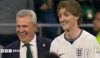 Javier Aguirre, who was manager for Mexico's game against England, and England winger Anthony Gordon share a laugh on the touchline