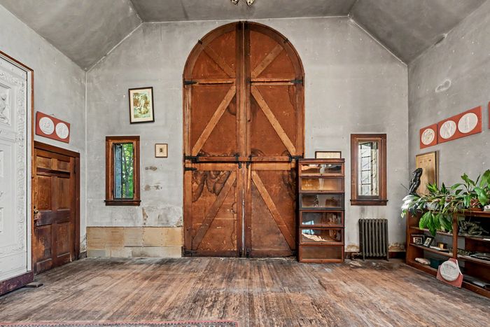 The interior. Barrister bookcases date to Nebel’s use of the studio, and the plaster medallions on the walls are his work.