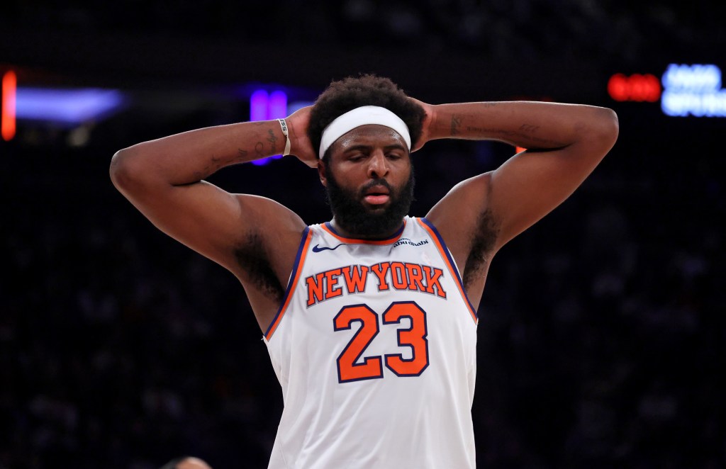 Knicks center Mitchell Robinson #23 reacts on the court during the first half.