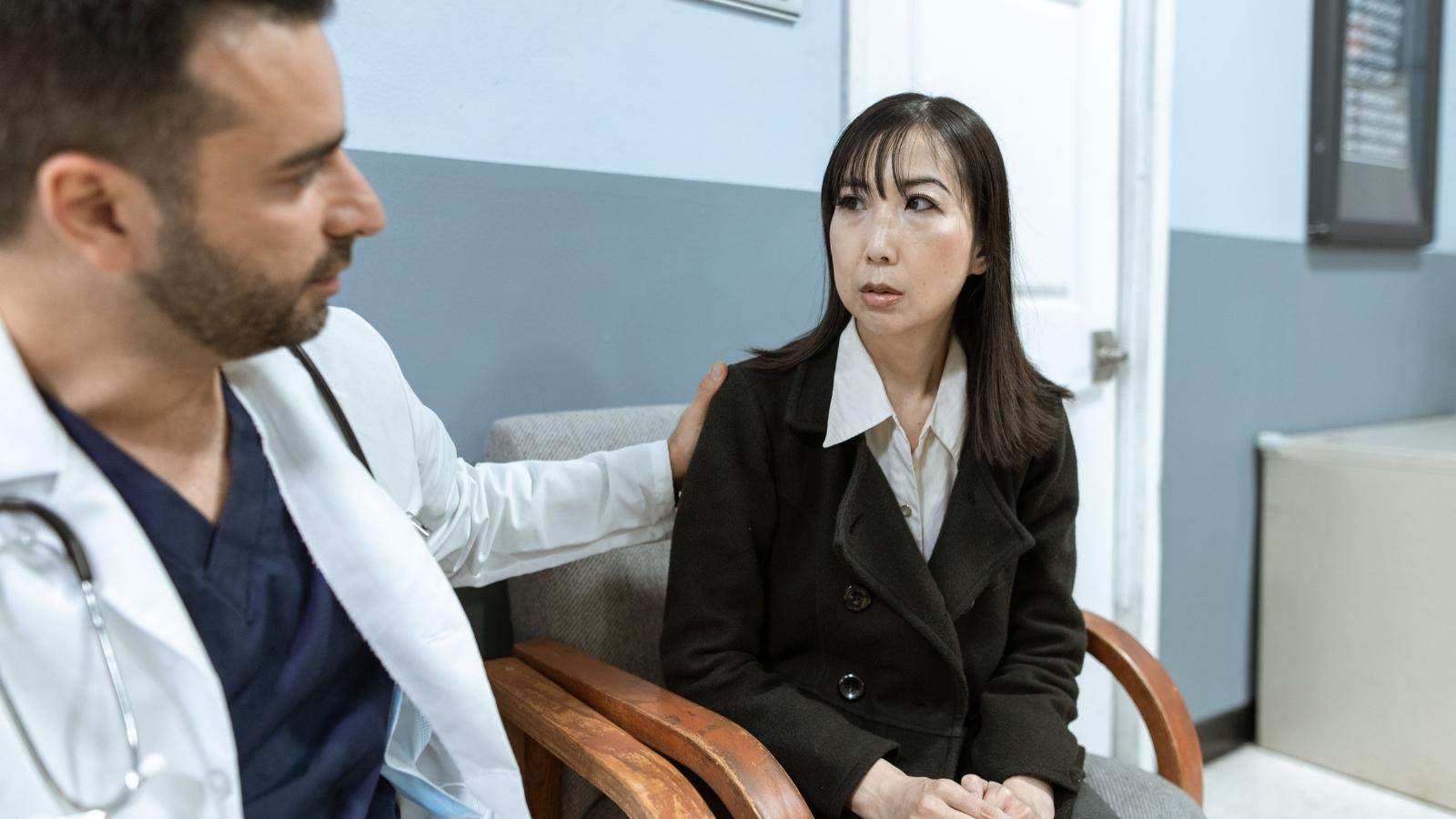 doctor comforting a professional woman