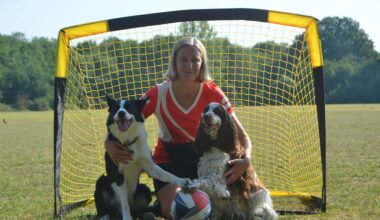 Olga Jones with her dogs Bonnie and Simba posing in front of a football goal