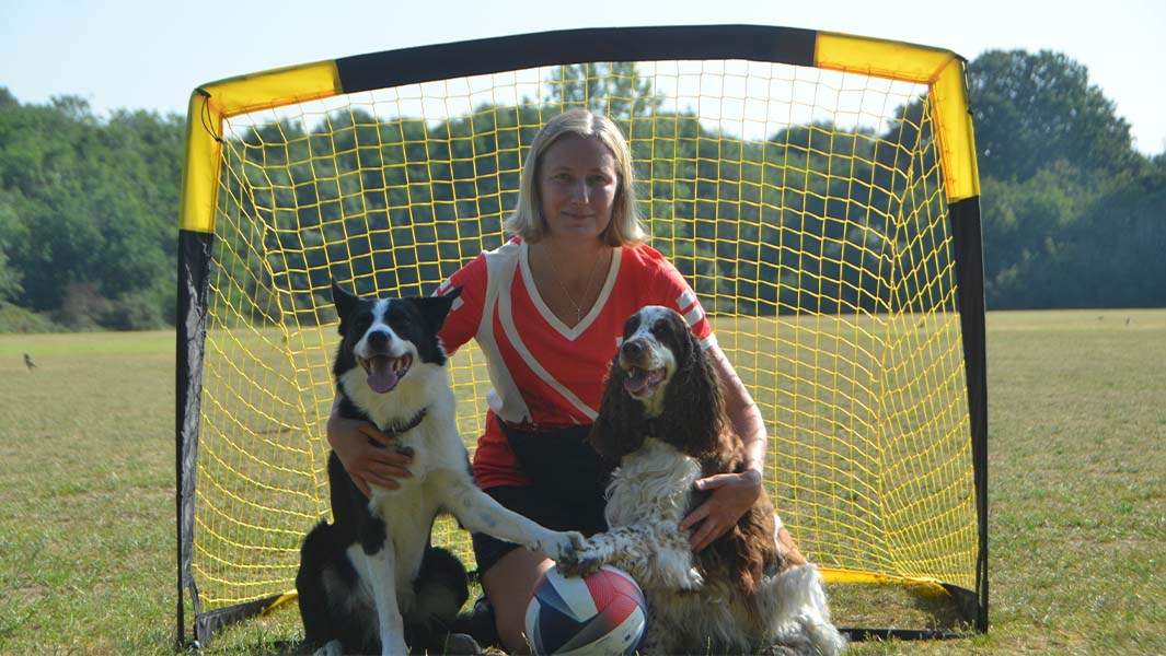 Olga Jones with her dogs Bonnie and Simba posing in front of a football goal