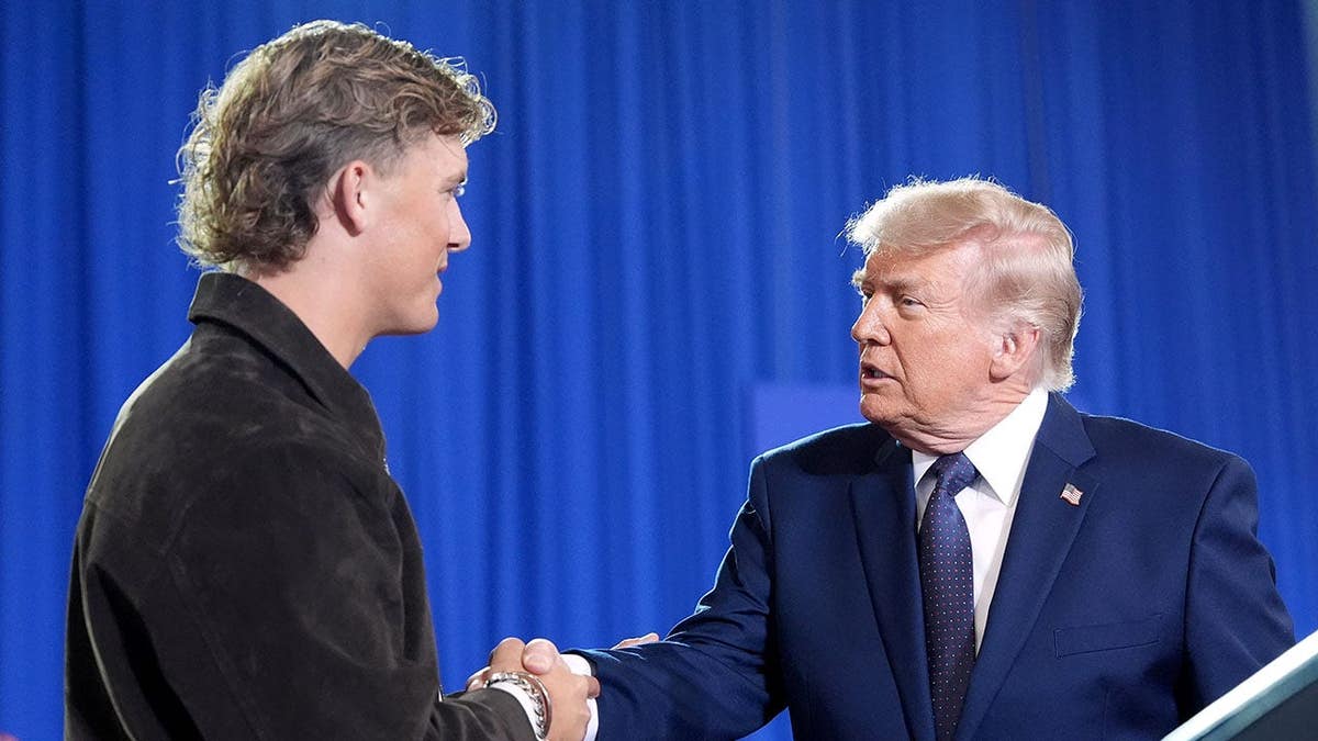 President Donald Trump shaking hands with New York Giants quarterback Jaxson Dart at Rockland Community College