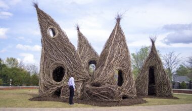 a whimsical, architectural public art sculpture made from interwoven twigs and saplings