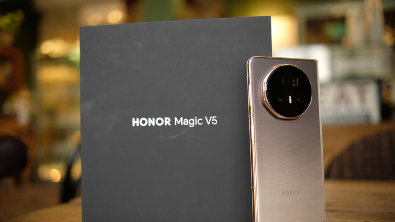 Honor Magic V5 foldable phone next to its packaging box
