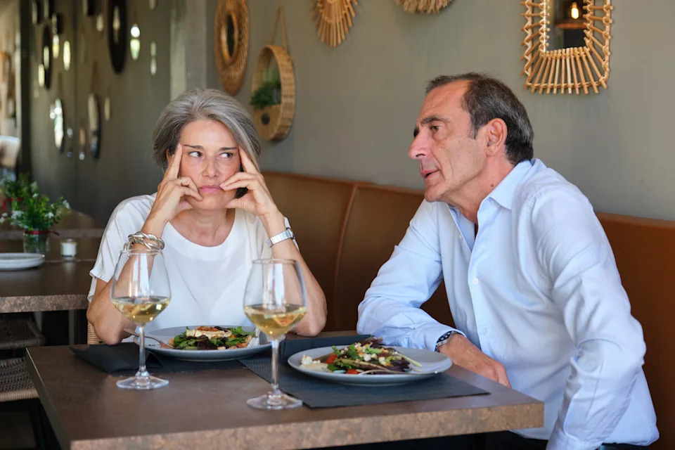 Mature couple having a bad time at the restaurant, arguing about something