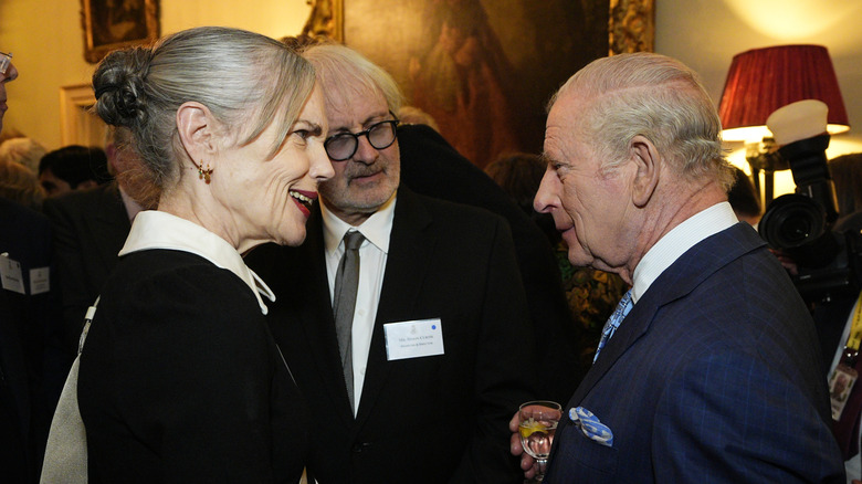 Elizabeth McGovern with King Charles III and another gentleman at an event