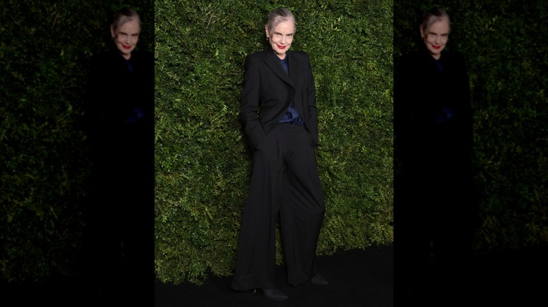 Elizabeth McGovern with gray hair and a black suit