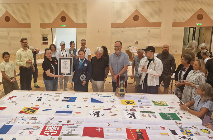 GWR Adjudicator holding certificate with the group in front of the embroidery