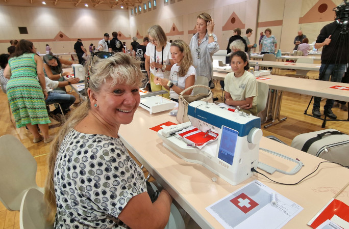 A lady and a child working on the embroidery machines