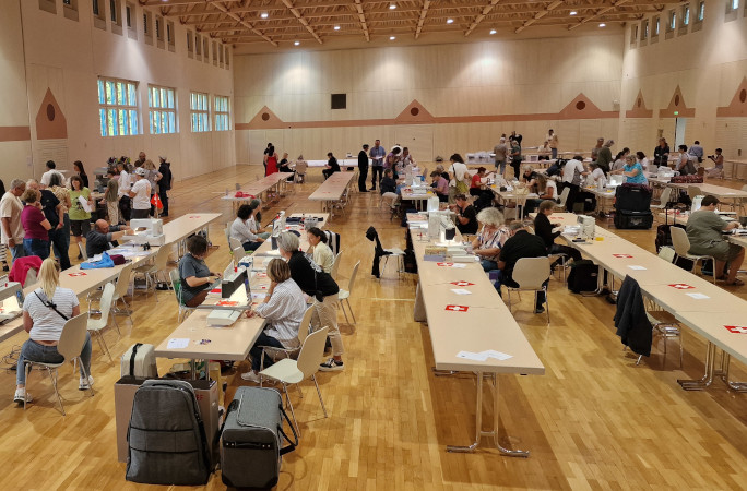 People sitting at tables in the event hall