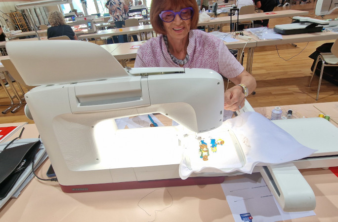 A woman using the embroidery machine