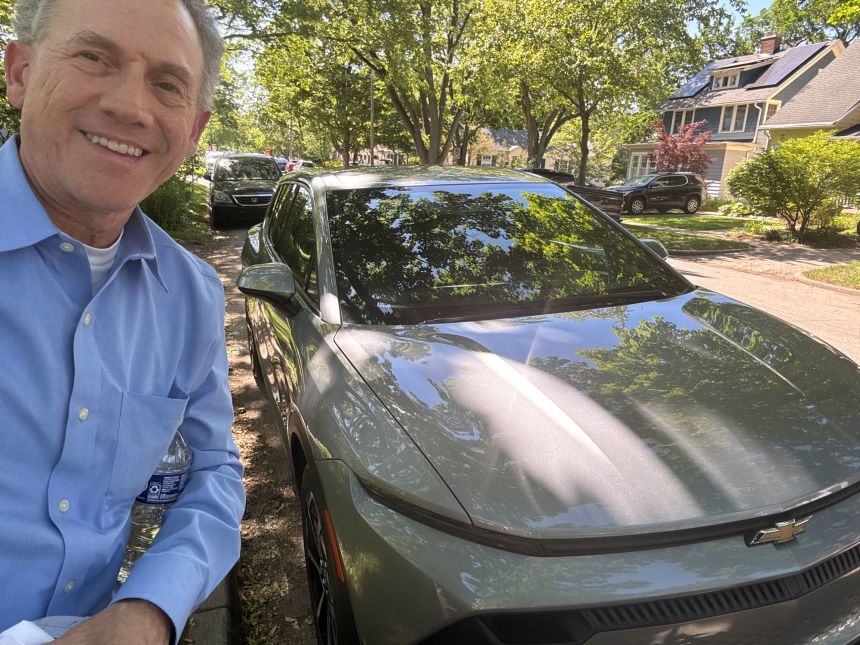 Eric Straka stands with a Equinox EV that he recently bought.