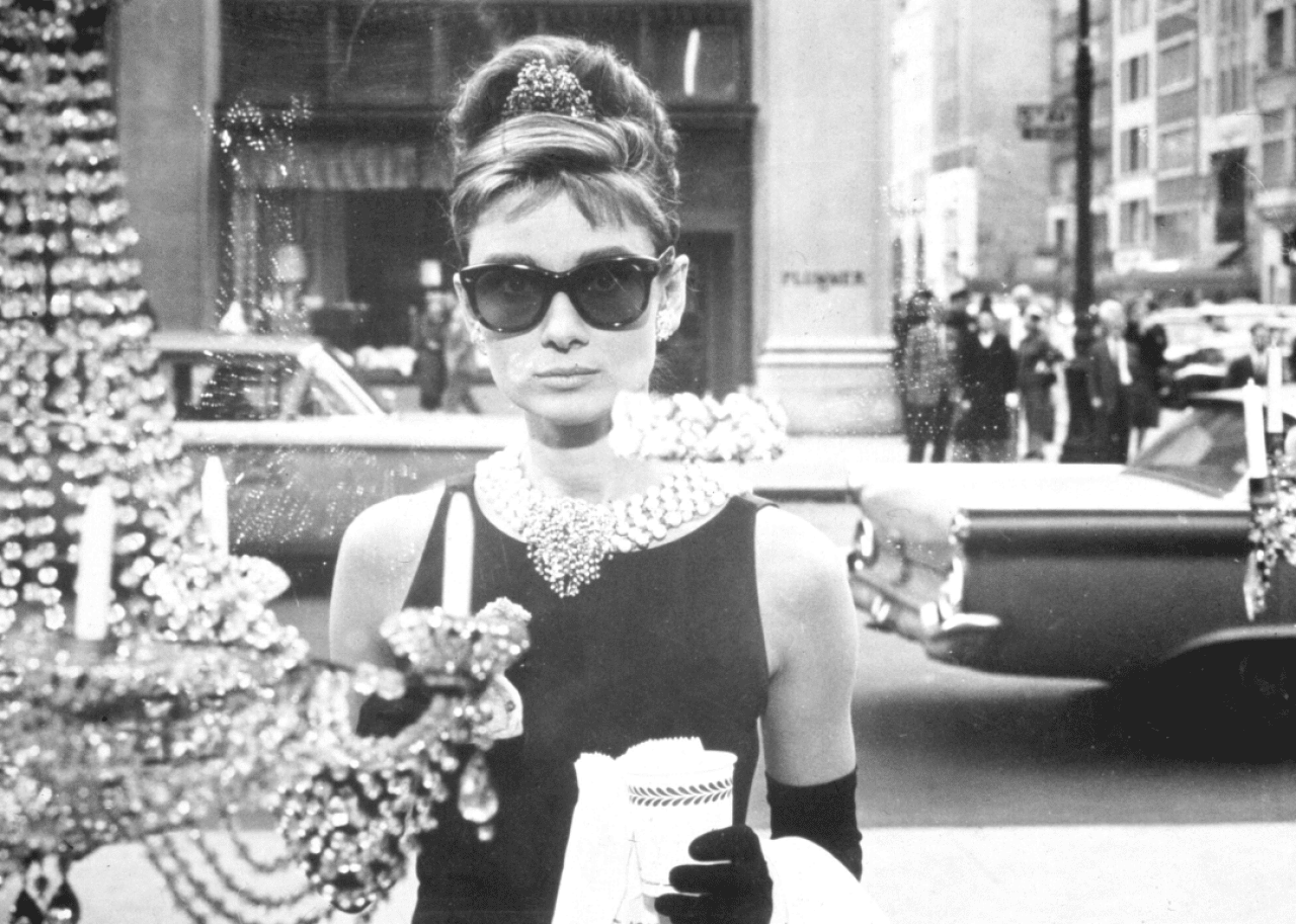 Audrey Hepburn looks into a window a Tiffany’s in a still from the film 'Breakfast at Tiffany’s.' -