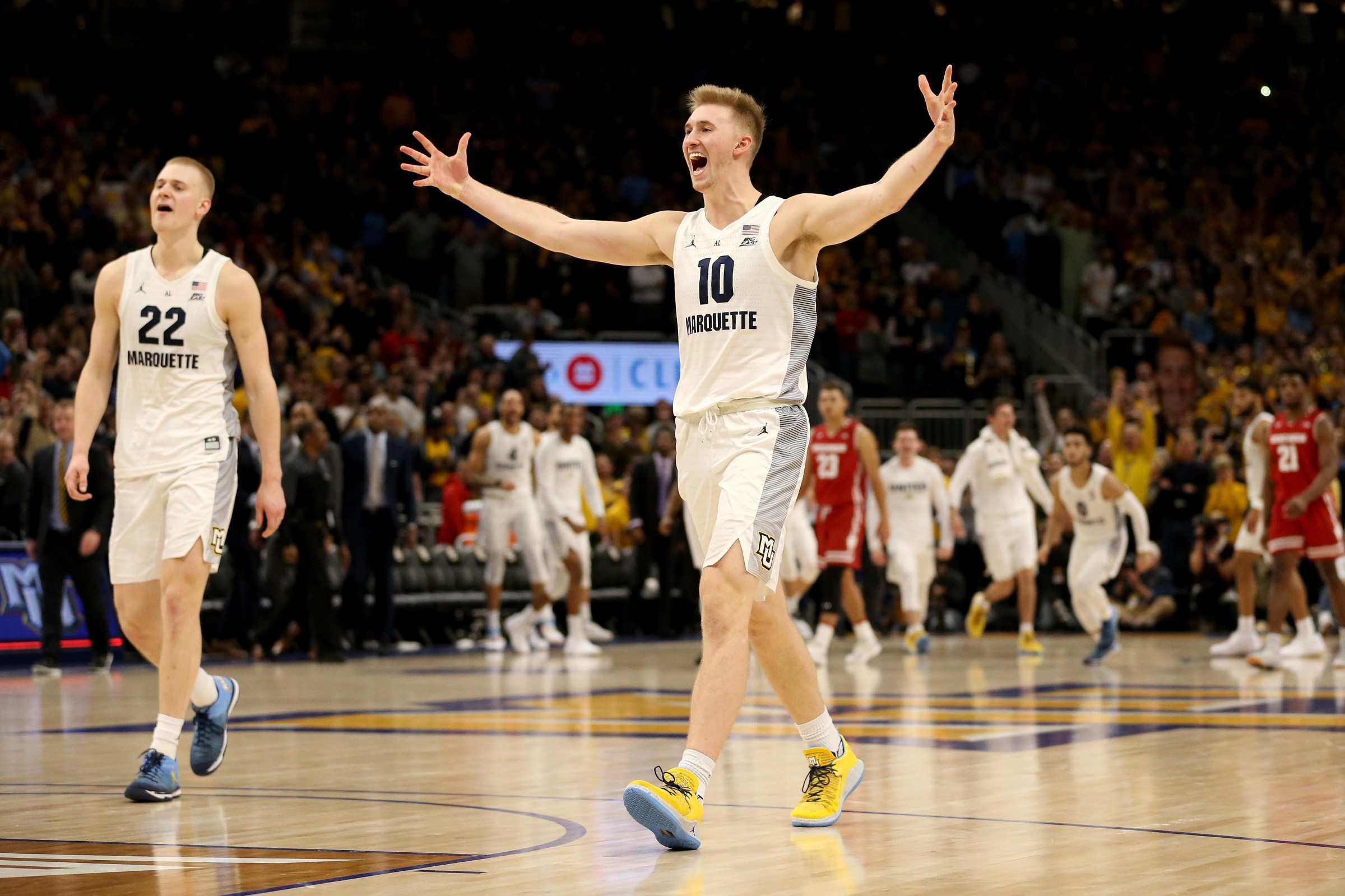 MILWAUKEE, WISCONSIN - DECEMBER 08: Joey Hauser #22 and Sam Hauser #10 of the Marquette Golden Eagles celebrate after beating the Wisconsin Badgers 74-69 in overtime at the Fiserv Forum on December 08, 2018 in Milwaukee, Wisconsin. (Photo by Dylan Buell/Getty Images)