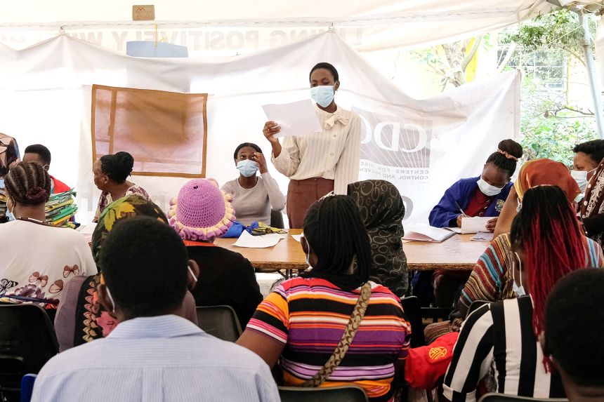 An AIDS support counsellor speaks to clients during a clinic day in February 2025 in Kampala, Uganda, as part of a range of services supported by CDC.