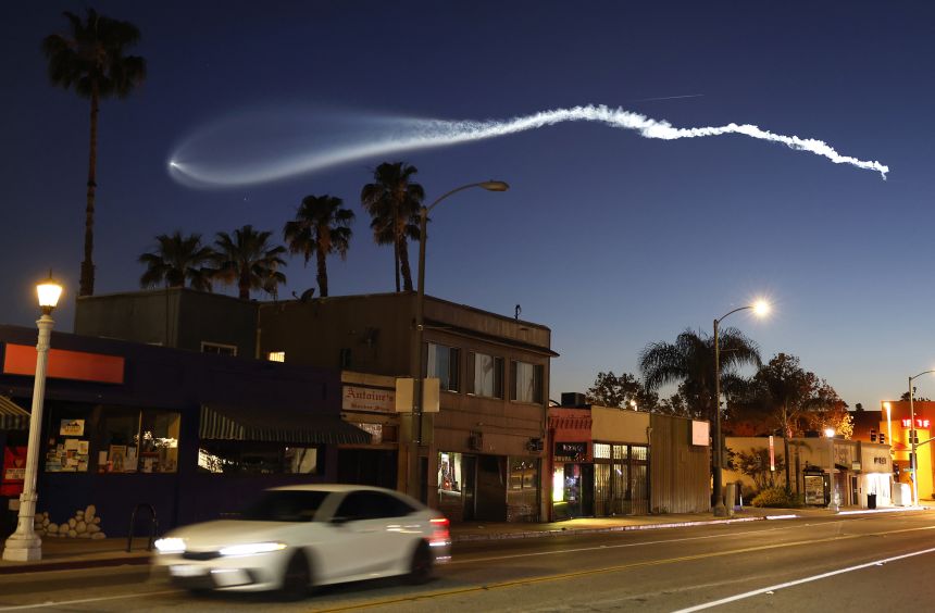A SpaceX Falcon 9 rocket rises after launching from Vandenberg Space Force Base carrying 25 Starlink internet satellites, as seen from Pasadena, California, on April 6.