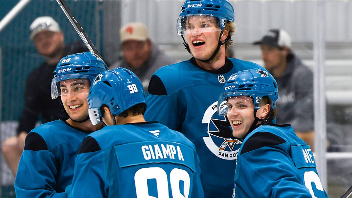 New San Jose Sharks draft pick Alexander Karmanov (84) is embraced by his teammates after a practice at Sharks Ice at San Jose in San Jose, Calif. on Tuesday, June 30, 2026. (Photo by Jessica Christian/San Francisco Chronicle via Getty Images)