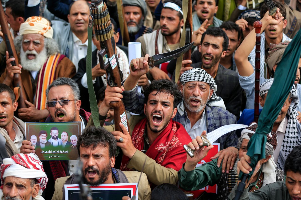 Armed Yemeni supporters of the Iran-backed Houthi movement brandish their weapons during a protest against what the group says are restrictions imposed by the Saudi-led coalition on Houthi-controlled areas of Yemen, in Sanaa on July 17.