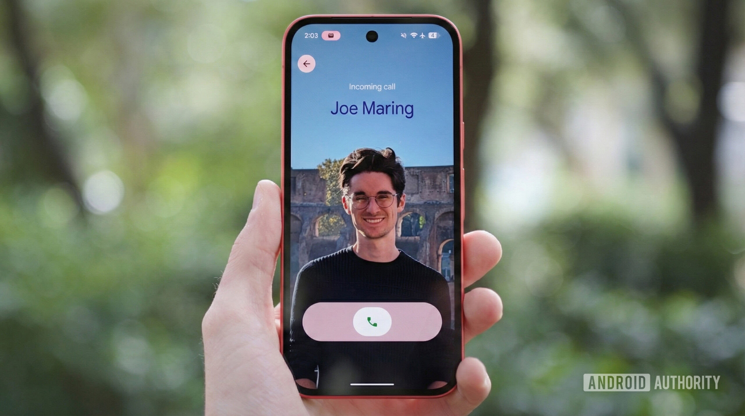 google phone personal calling cards hero Someone holding a Google Pixel phone with a Calling Card displayed on it.