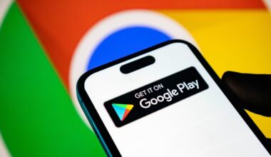Google Play logo on a smart phone with the Google logo in the background.