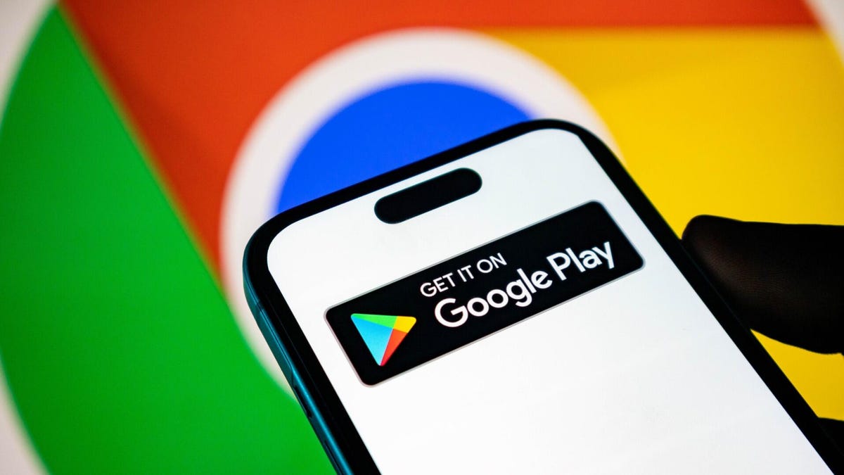 Google Play logo on a smart phone with the Google logo in the background.