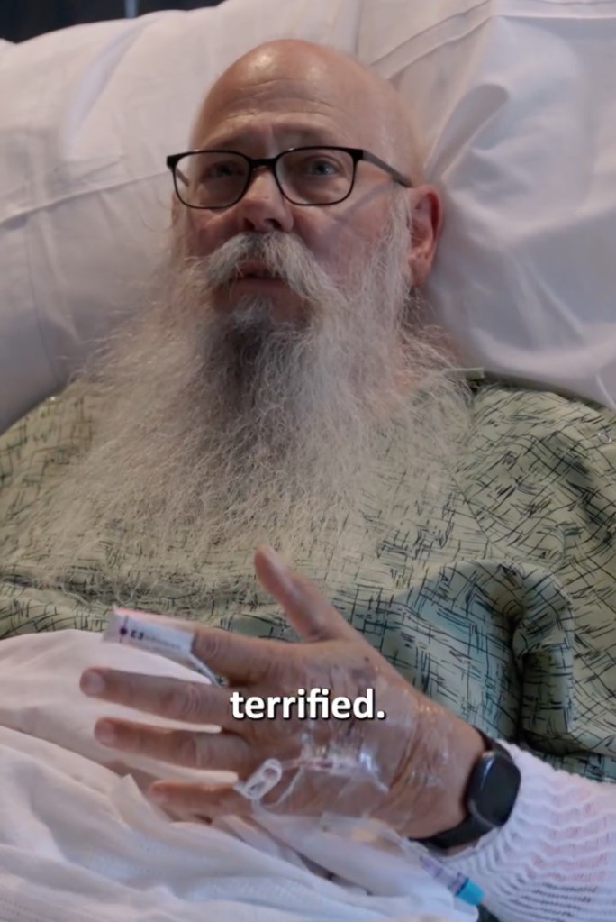 Carl McDaniel in a hospital bed with an IV in his hand, after being attacked by a bison.