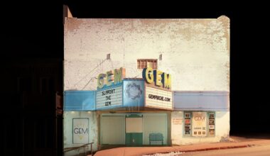 an atmospherically illuminated photograph of a vintage theater called the Gem against an eerily deep black background