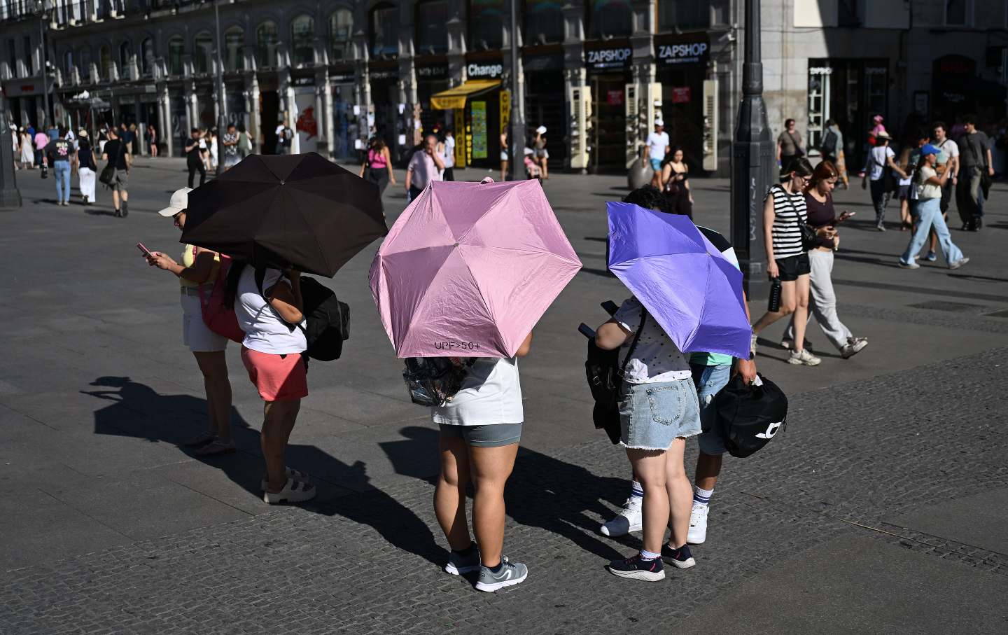 People protect themselves from the heat wave that affects daily life as high temperatures continue, on June 26, 2026, in Madrid, Spain.