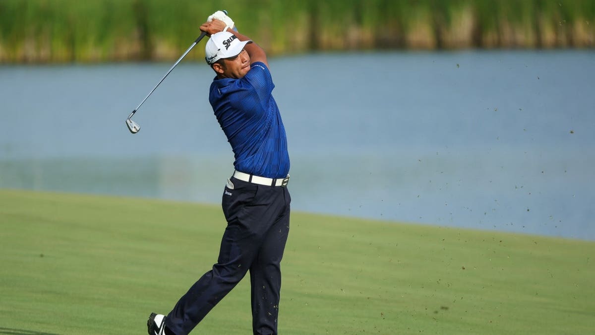 Hideki Matsuyama hits his approach shot on the 14th hole during the 3M Open 2023 at TPC Twin Cities in Blaine, Minnesota.