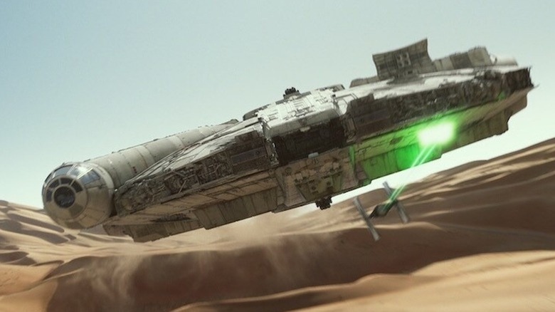 The Millennium Falcon tracks a tie-fighter in the desert in Star Wars: The Force Awakens