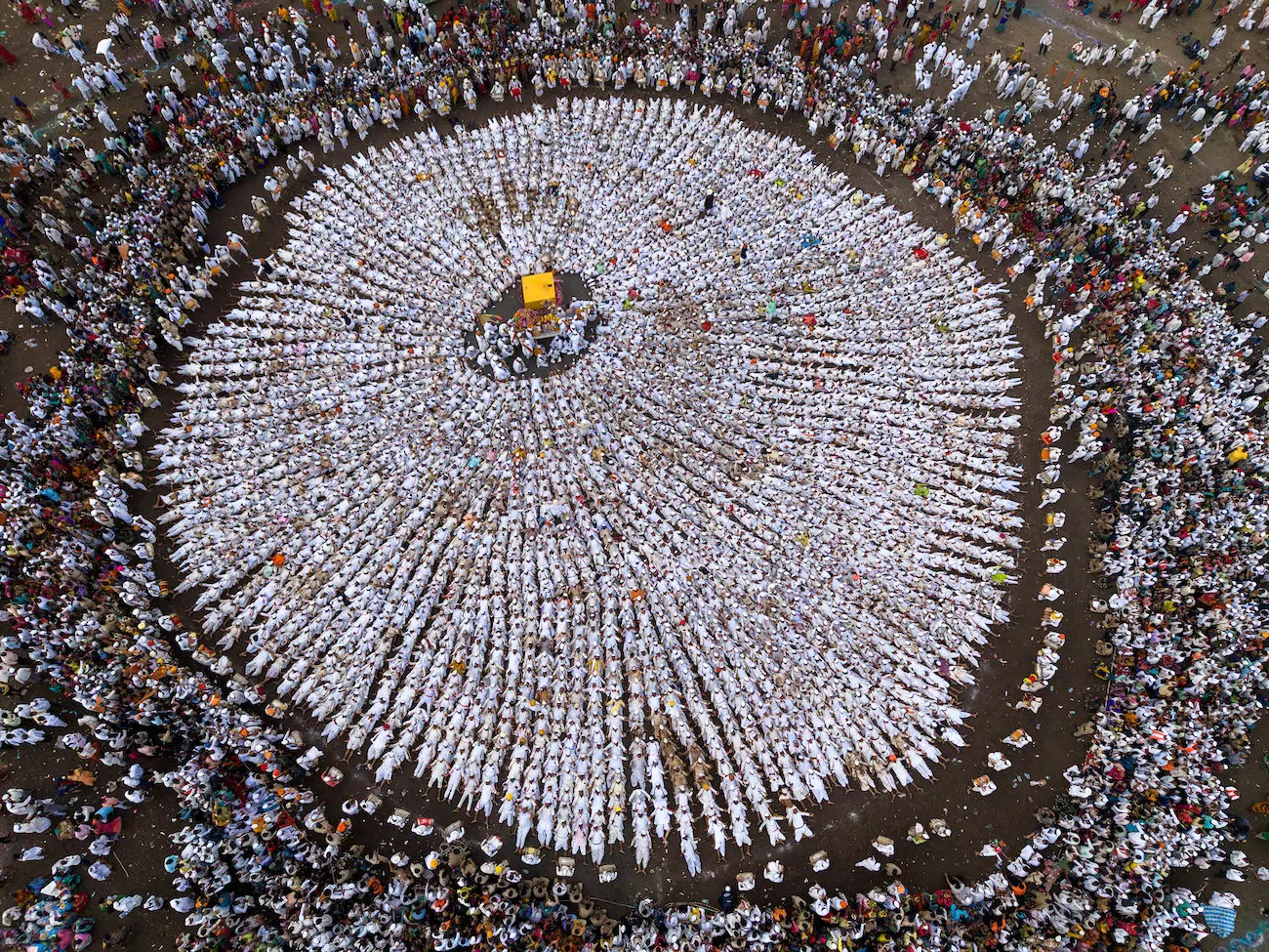 Sanghamitra Sarkar, India. Wari. A gathering of Warkaris during Maharashtra’s Wari pilgrimage forms a circular pattern around the central palkhi carrying sacred padukas. Dressed in white, devotees sit in rows, creating a powerful visual of unity, devotion and harmony.