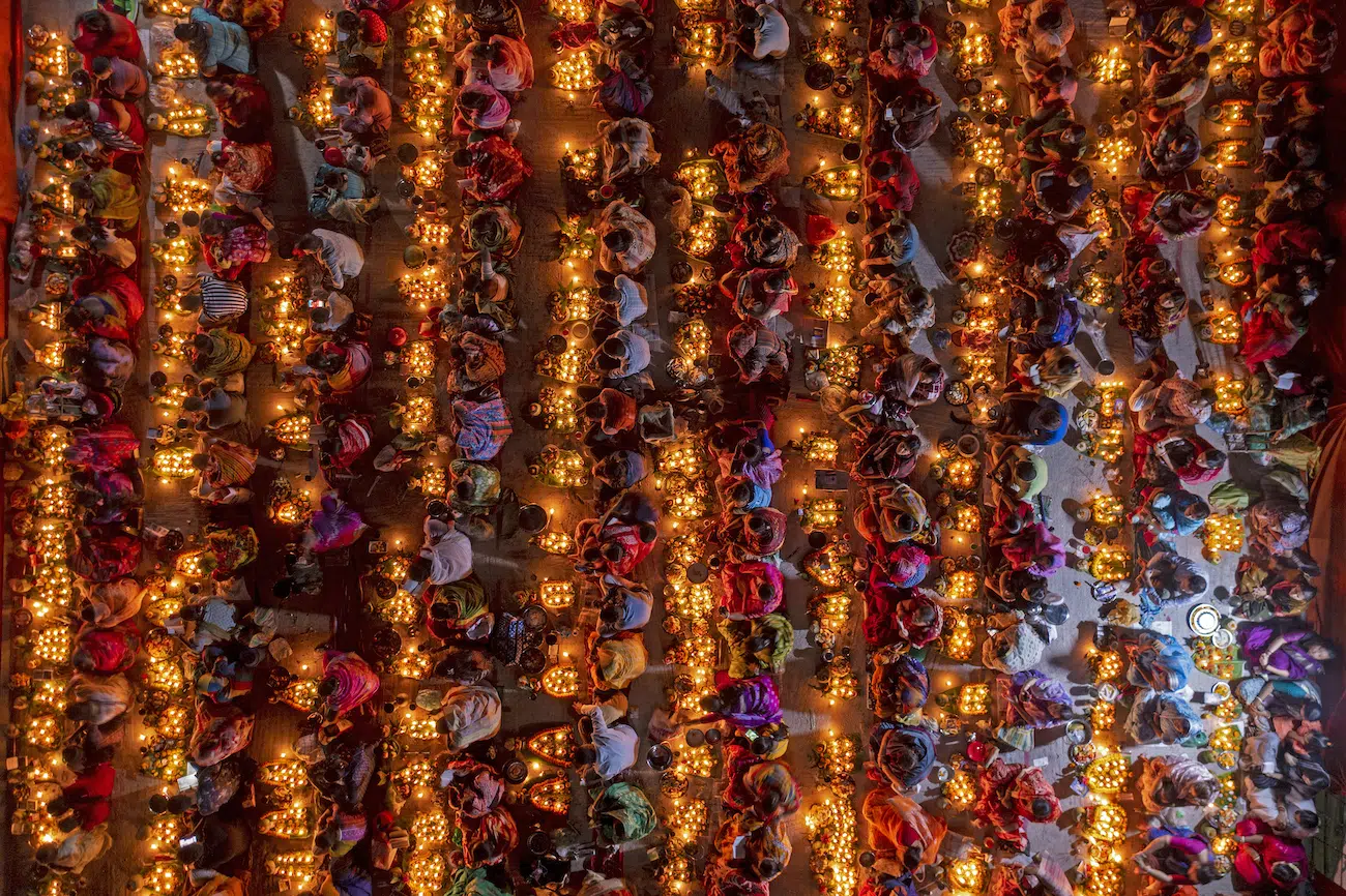 Azim Khan Ronnie, Bangladesh. Fasting Festival. Hindu devotees gather in Dhaka for Rakher Upobash, fasting and praying with incense and oil lamps to honour Baba Lokenath. Thousands seek blessings for health and protection, recalling the 18th century saint’s life of asceticism and spiritual devotion.