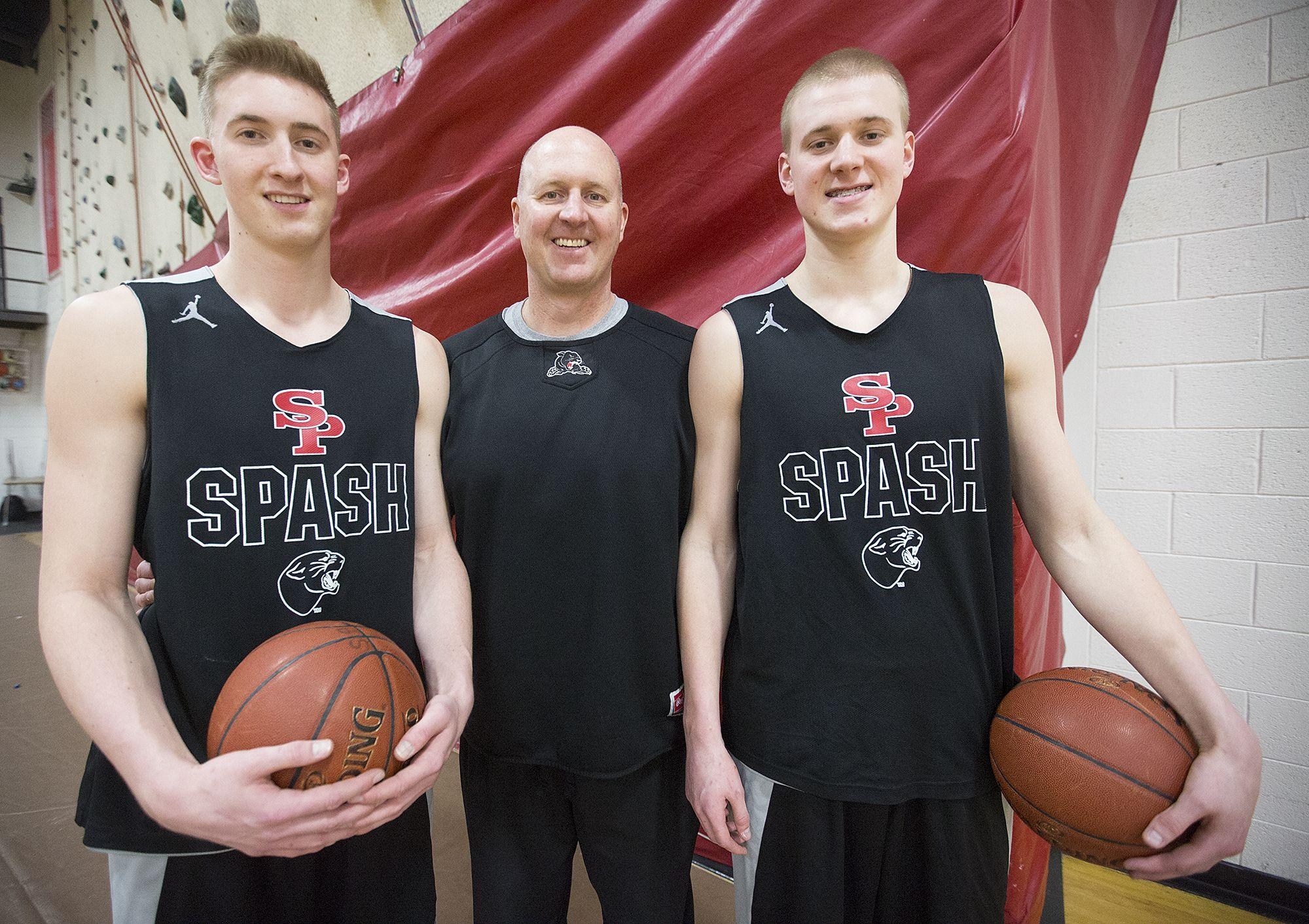 Assistant coach Dave Hauser (center), with his sons Sam Hauser (left), and Joey Hauser (right), during basketball practice at Stevens Point Area Senior High School, March 9, 2016. HAUSER17p2