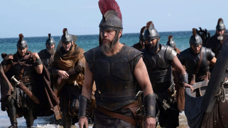 Odysseus and his men in full armor on a beach in The Odyssey
